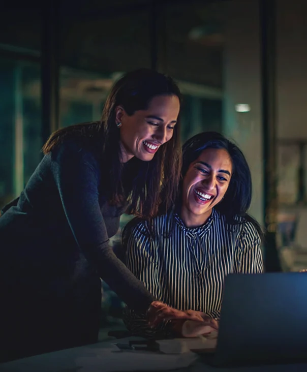 two-colleagues-collaborate-at-a-desk-sharing